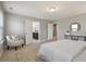 Bright main bedroom featuring neutral decor, an accent chair, and ensuite bathroom access at 214 Center Hill Ct, Summerville, SC 29485
