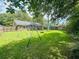 A large backyard with a swing set and an unfenced fire pit at 214 Four Iron Dr, Summerville, SC 29483
