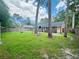 View of the backyard and patio area with mature trees and lawn at 214 Four Iron Dr, Summerville, SC 29483