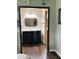 Bathroom view from the bedroom featuring wood-look floors and decorative mirror at 214 Four Iron Dr, Summerville, SC 29483