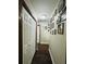 Hallway with beautiful hardwood floors and unique framed portraits at 214 Four Iron Dr, Summerville, SC 29483