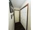 Hallway with wood-look flooring, white doors, and framed pictures hanging on the wall at 214 Four Iron Dr, Summerville, SC 29483