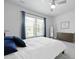 Bedroom with modern ceiling fan, large window with blue curtains and a wood dresser at 220 Garden Gate Way, Summerville, SC 29486