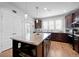 Kitchen island features a granite countertop, dark wood cabinets, and pendant lighting at 220 Garden Gate Way, Summerville, SC 29486