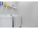 Laundry room with modern, white Samsung washer and dryer and wire shelving at 220 Garden Gate Way, Summerville, SC 29486
