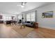 Comfortable living room and dining area with hardwood floors, large windows, and modern decor at 220 Garden Gate Way, Summerville, SC 29486