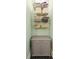 Bathroom cabinet with drawers topped with chrome shelves holding towels and bath supplies at 222 E Main St, Moncks Corner, SC 29461