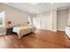 Spacious main bedroom featuring a decorative ceiling, wood floors, and dual sliding-door closets at 222 E Main St, Moncks Corner, SC 29461