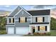 Charming two-story home showcasing a stylish gray exterior, well-manicured lawn, and an attached two-car garage at 225 Wild Strawberry Ln, Moncks Corner, SC 29461