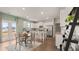 Open-concept kitchen with an island, white cabinets, stainless steel appliances, and a dining area at 225 Wild Strawberry Ln, Moncks Corner, SC 29461