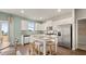 Well-lit kitchen featuring stainless steel appliances, a center island with seating, and ample counter space at 225 Wild Strawberry Ln, Moncks Corner, SC 29461