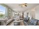 Cozy living area showcasing hardwood floors, stylish seating, and a seamless transition to the bright, airy kitchen at 225 Wild Strawberry Ln, Moncks Corner, SC 29461