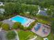 Aerial view of the community pool and playground nestled among lush trees and landscaping at 230 Sweet Alyssum Dr, Ladson, SC 29456