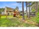 Large, treed backyard featuring a playset, trampoline, and hammock, perfect for Gathering fun at 230 Sweet Alyssum Dr, Ladson, SC 29456