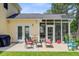 Outdoor patio with seating, perfect for enjoying the landscaped backyard and adjacent screened porch at 230 Sweet Alyssum Dr, Ladson, SC 29456