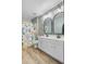 Bright bathroom boasts a dual sink vanity, modern mirrors, and elegant lighting fixtures at 230 Sweet Alyssum Dr, Ladson, SC 29456