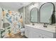 Bright bathroom boasts a dual sink vanity, modern mirrors, and elegant lighting fixtures at 230 Sweet Alyssum Dr, Ladson, SC 29456