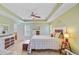 Spacious bedroom features a tray ceiling, ceiling fan, and an en-suite bathroom at 230 Sweet Alyssum Dr, Ladson, SC 29456