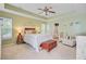 A main bedroom with a tray ceiling, ceiling fan, and en suite bathroom at 230 Sweet Alyssum Dr, Ladson, SC 29456