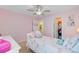Pink bedroom with a ceiling fan, twin bed, and ensuite bathroom access, creating a cozy, personalized space at 230 Sweet Alyssum Dr, Ladson, SC 29456
