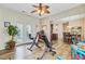 A bonus room connecting to the dining room with exercise equipment and a ceiling fan at 230 Sweet Alyssum Dr, Ladson, SC 29456