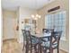 A dining room with a wood table, chandelier lighting, and large window at 230 Sweet Alyssum Dr, Ladson, SC 29456
