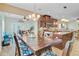 A dining room that opens to a kitchen with a breakfast bar at 230 Sweet Alyssum Dr, Ladson, SC 29456
