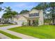 Charming two-story home with yellow siding, black shutters, well-manicured lawn and beautiful landscaping at 230 Sweet Alyssum Dr, Ladson, SC 29456