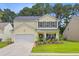 Charming two-story home with yellow siding, black shutters, well-manicured lawn and beautiful landscaping at 230 Sweet Alyssum Dr, Ladson, SC 29456
