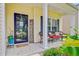 Inviting front porch with cozy seating, decorative plants, and a charming welcome sign at 230 Sweet Alyssum Dr, Ladson, SC 29456