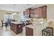 Well-designed kitchen with dark cabinets, granite countertops, and adjacent dining area at 230 Sweet Alyssum Dr, Ladson, SC 29456