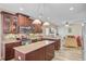 Updated kitchen with stainless steel appliances, dark wood cabinets, and a granite island at 230 Sweet Alyssum Dr, Ladson, SC 29456