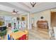 Open-concept living room with light-filled windows, wood floors, piano, and built-in bookshelves at 230 Sweet Alyssum Dr, Ladson, SC 29456