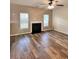 Living room featuring a fireplace, hardwood flooring, and natural light from windows at 230 Sweet Alyssum Dr, Ladson, SC 29456