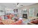 Relaxing living room flowing into the open kitchen area with a cozy fireplace at 230 Sweet Alyssum Dr, Ladson, SC 29456