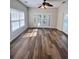 Bright living room with wood floors, ceiling fan, and view of outdoor area at 230 Sweet Alyssum Dr, Ladson, SC 29456