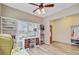 Bright office space with wood flooring, desk, bookshelves, and a view of the front yard at 230 Sweet Alyssum Dr, Ladson, SC 29456