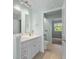 A well-lit bathroom features a double sink vanity, an adjacent toilet, and an open doorway at 2333 Tall Sail Dr # G 607, Charleston, SC 29414