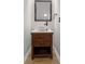 Stylish powder room with wood vanity, vessel sink, bronze fixtures, and modern mirror at 2333 Tall Sail Dr # G 607, Charleston, SC 29414