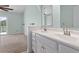 A charming bathroom featuring a double sink vanity, decorative mirror, and an arched doorway at 2333 Tall Sail Dr # G 607, Charleston, SC 29414