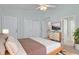 A bedroom features a queen bed, a modern dresser and a door leading to the hallway at 2333 Tall Sail Dr # G 607, Charleston, SC 29414