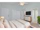 A bedroom features a queen bed, a modern dresser and a door leading to the hallway at 2333 Tall Sail Dr # G 607, Charleston, SC 29414