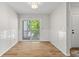 Living area with wainscoting, wood floors, and sliding glass doors leading to the outside at 2333 Tall Sail Dr # G 607, Charleston, SC 29414