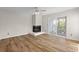 This living room features a fireplace, wood floor and sliding glass door to the outside at 2333 Tall Sail Dr # G 607, Charleston, SC 29414