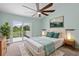 Cozy main bedroom with balcony, ceiling fan, and neutral decor and paint at 2333 Tall Sail Dr # G 607, Charleston, SC 29414
