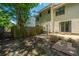 Backyard with green foliage, brick patio, and a wood fence at 235 Pine Shadow Dr, Goose Creek, SC 29445