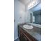 Bathroom vanity with granite countertop and dark wood cabinets at 235 Pine Shadow Dr, Goose Creek, SC 29445