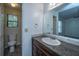 Well-lit bathroom featuring a granite countertop and a view of the shower and the bedroom at 235 Pine Shadow Dr, Goose Creek, SC 29445