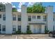 Inviting townhouse with light yellow siding, complemented by lush green bushes and ample parking at 235 Pine Shadow Dr, Goose Creek, SC 29445