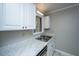 Bright kitchen sink area with white cabinets, modern countertops, and stainless steel sink at 235 Pine Shadow Dr, Goose Creek, SC 29445